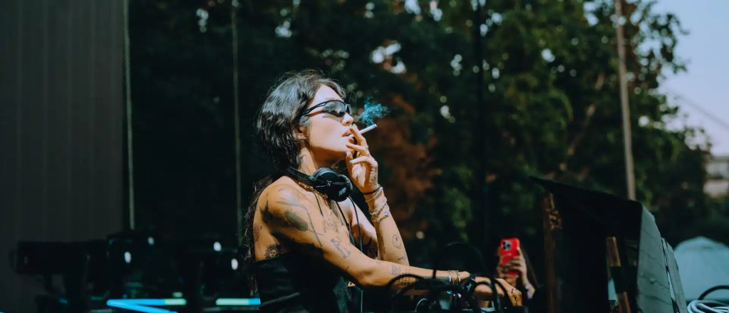 Debut Peggy Gou Album "I Hear You": A Solo Masterpiece Peggy Gou smoking cigarettes while performing to a live audience