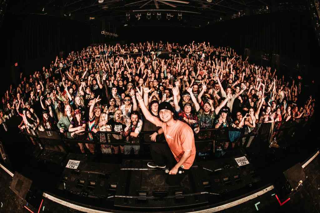 Tape B with crowd Tape B taking a wholesome photo with fans at live concert