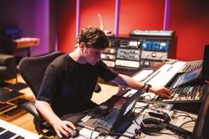 Martin Garrix producing dance music in his studio